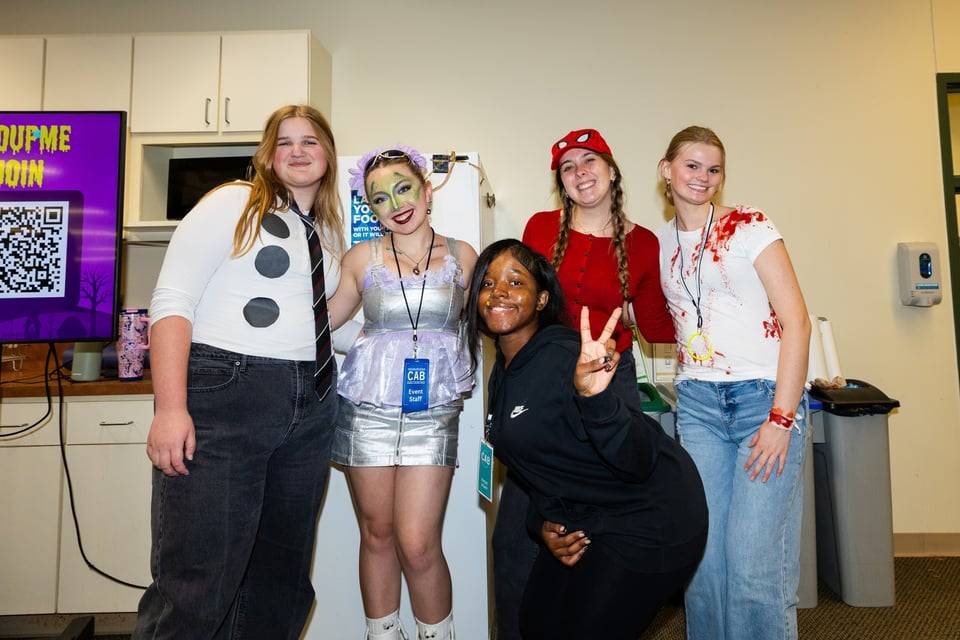 Student volunteers smiling at camera